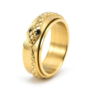 Three rings with snake designs on them, displayed on a dark background. The rings come in different metallic finishes: black, gold, and silver.