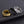 Three rings designed like a snake, with gold and silver color options and a hypoallergenic gold plating, displayed on a dark background.