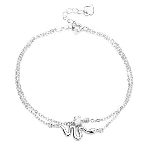 Silver bracelet with a wave design on a white background