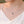 Silver necklace with a pendant on a model wearing a white top.