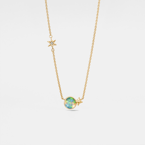 Gold necklace with a star and opal pendant on a light gray background