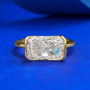 Gold ring with a large diamond on a blue background