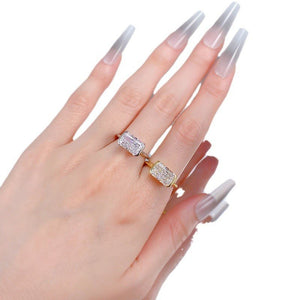 Hand wearing a diamond ring with a white background