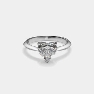 Heart-shaped diamond ring on a light gray background