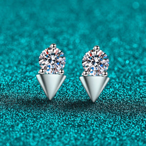Pair of silver earrings with gemstones on a teal glittery background