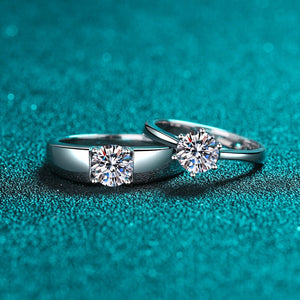 Two silver diamond rings on a teal textured background