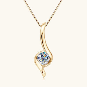 Gold pendant with a diamond on a white background