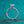 Silver ring with a diamond on a teal glitter background