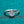Silver ring with a diamond on a teal background