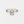 Gold ring with a diamond on a light gray background