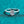 Silver ring with a diamond on a teal textured background