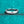 Silver ring with a diamond on a turquoise glittery background