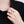 Hand wearing a silver ring with a black background
