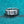 Silver ring with a diamond on a teal background