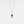A silver and gold necklace featuring a spaceman and moon charm with a gold plating on a sterling silver base.