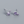 Pair of purple square gemstone earrings on a gray background