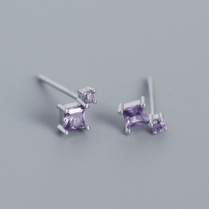 Pair of purple square gemstone earrings on a gray background
