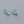 Pair of turquoise square stud earrings on a gray background