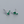 Pair of emerald green gemstone earrings on a light gray background