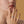 Close-up of a woman's hand wearing an engagement ring with a yellow background