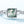 Silver ring with a green gemstone on a light blue background