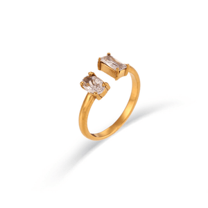 Gold ring with two gemstones on a white background