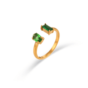 Gold ring with green gemstones on a white background