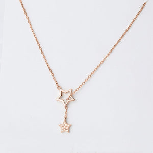 Two necklaces, one with a gold finish and the other with a silver finish, each featuring a star pendant, displayed against a white background.