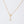 Gold star-shaped necklace on a light gray background