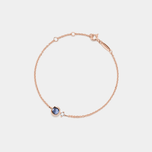 A rose gold-plated bracelet made of sterling silver, featuring a central charm with a photo projection, complemented by smaller clear cubic zirconia on the chain.