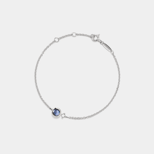 A white gold-plated bracelet made of sterling silver, featuring a central charm with a photo projection, complemented by smaller clear cubic zirconia on the chain.
