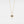 Gold necklace with a star-shaped pendant on a light gray background