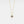 Gold necklace with a star-shaped pendant on a light gray background
