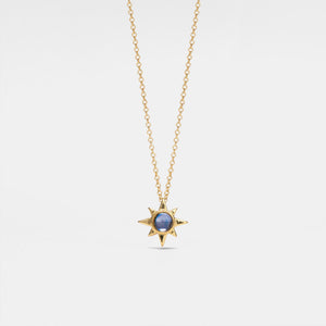 Gold necklace with a star-shaped pendant on a light gray background