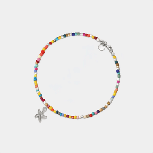 A colorful beaded anklet with a gold-plated starfish charm and adjustable chain.