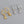 Gold and silver hoop earrings with starfish charms on a gray background