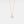 A rose gold-plated sterling silver necklace with a sun charm pendant on a chain.