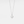 A white gold-plated sterling silver necklace with a sun charm pendant on a chain.