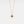 Gold necklace with a sun-shaped pendant featuring a blue gemstone on a white background