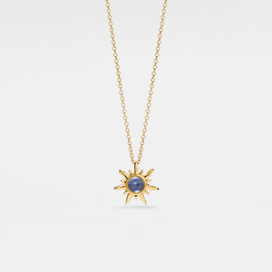 Gold necklace with a sun-shaped pendant featuring a blue gemstone on a white background