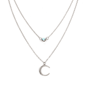 Two silver necklaces with moon pendants on a white background