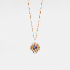 A rose gold-plated sterling silver necklace with a sunflower charm and a central projection stone, displayed on a white background.