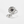 Silver sunflower-shaped ring with a central projection gemstone on a white background