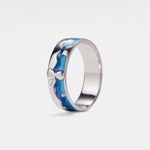 A silver band ring with blue enamel design featuring the lttle prince and a star