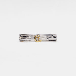 Silver ring with gold little prince sitting on the moon on a white background