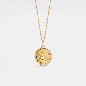 Gold plated round locket necklace featuring a “Little Prince” engraved design with a star detail, on a delicate chain against a clean white background.