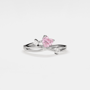 Silver vine ring with a pink heart-shaped gemstone on a white background