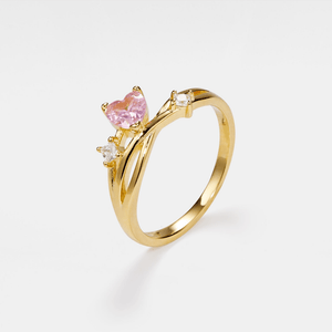 Gold vine ring with a pink heart-shaped gemstone on a white background