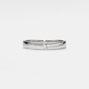 Silver band ring with a shooting star pattern on a white background