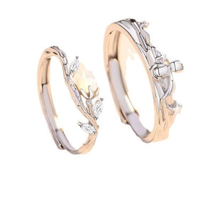 Two silver rings with the little prince and rose flower designs on a white background